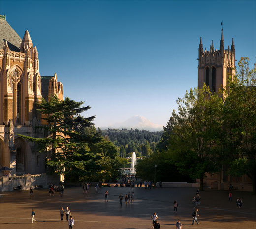 photo of the UW Campus with historic buildings and fountain, the massive snowy dome of Mount Rainier looming in the distance