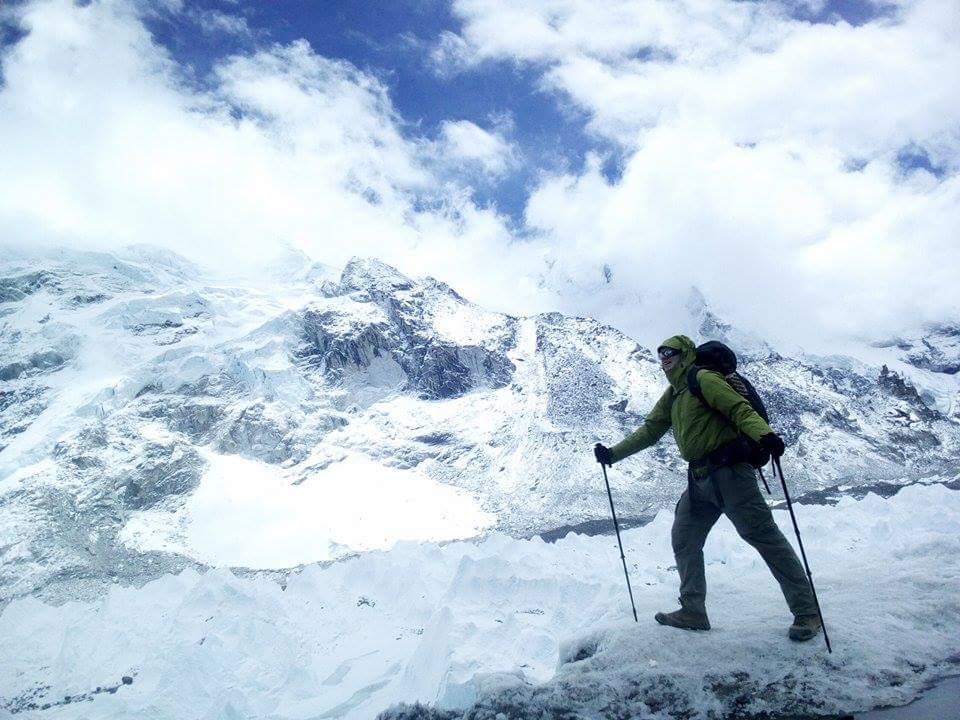 Terrill at Everest Base Camp, surrounded by glistening white snow and ice